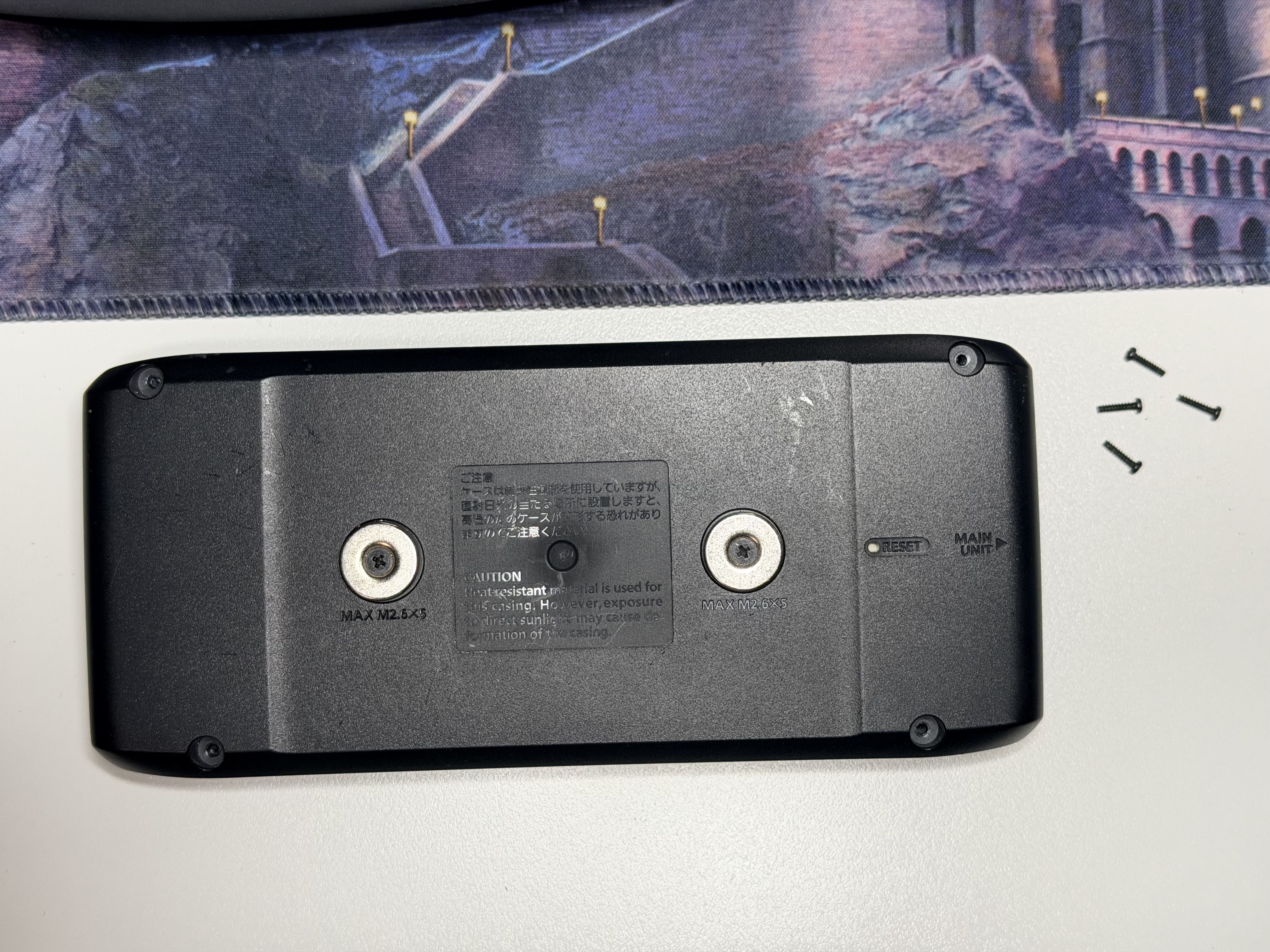 Back cover removed from the ID-5100A head unit with screws set aside.