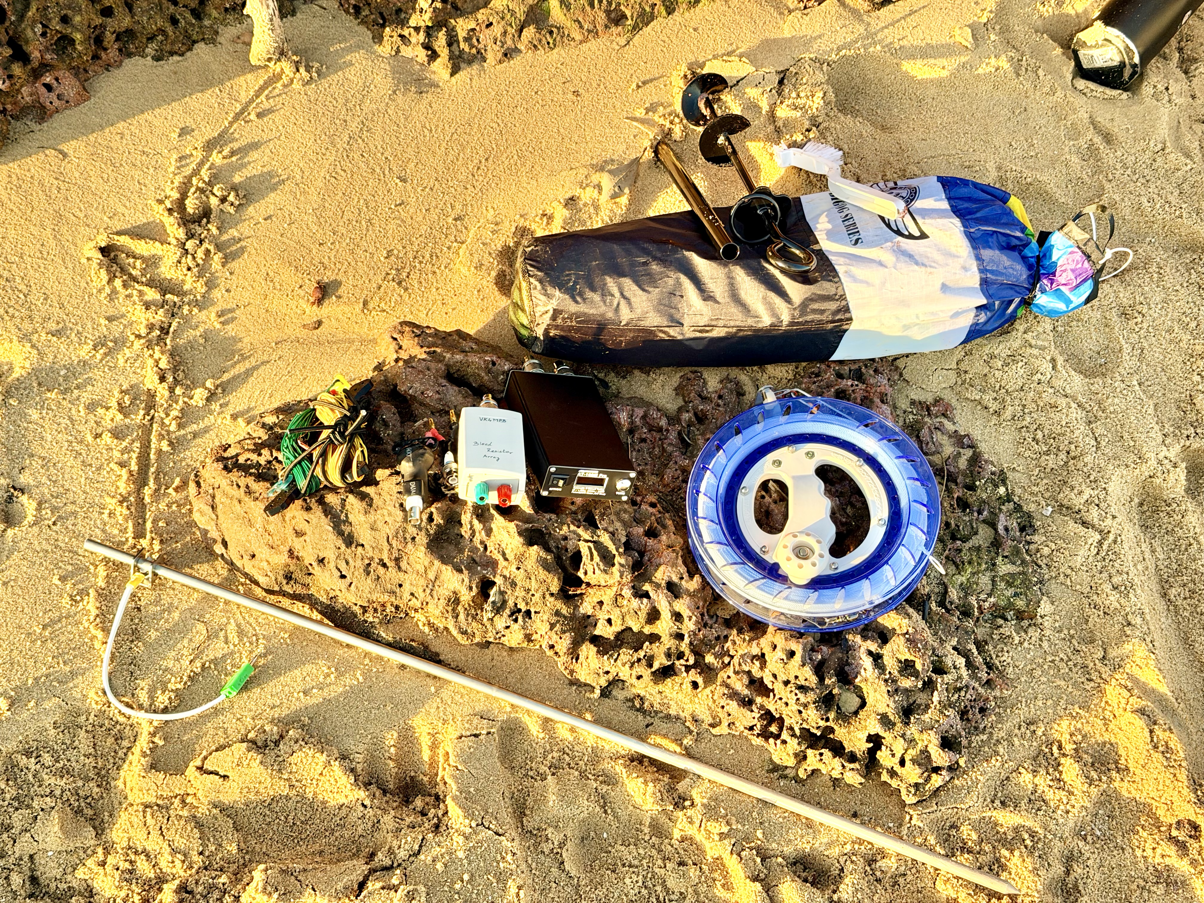 Complete activation kit laid out on the sand before or after deployment